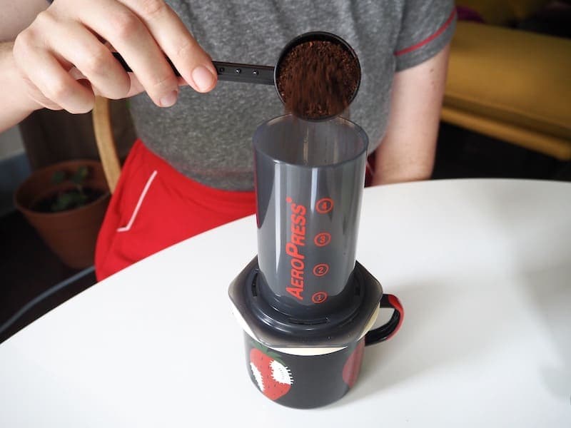 Pour ground coffee into AeroPress