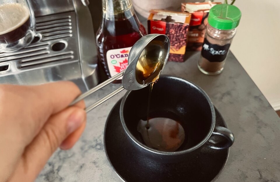 mixing maple syrup and spices for maple latte