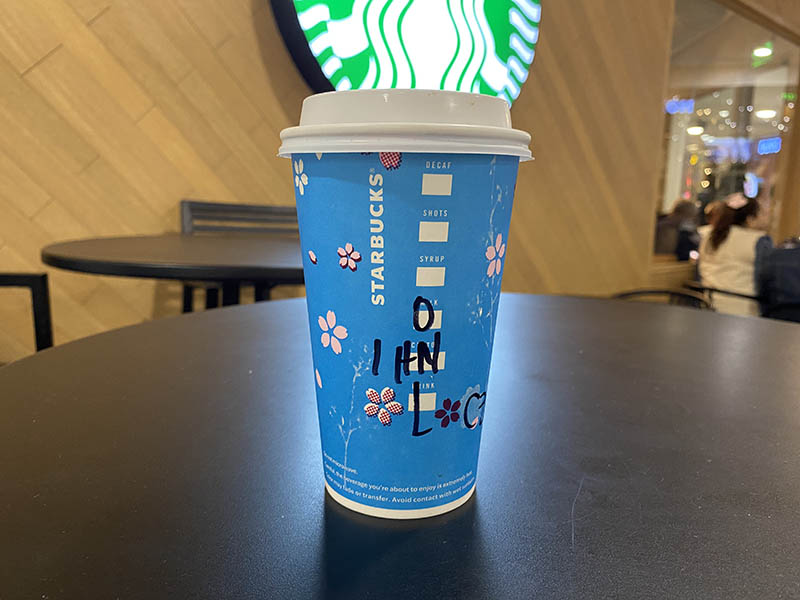 a cup of hot honey oat latte on a table