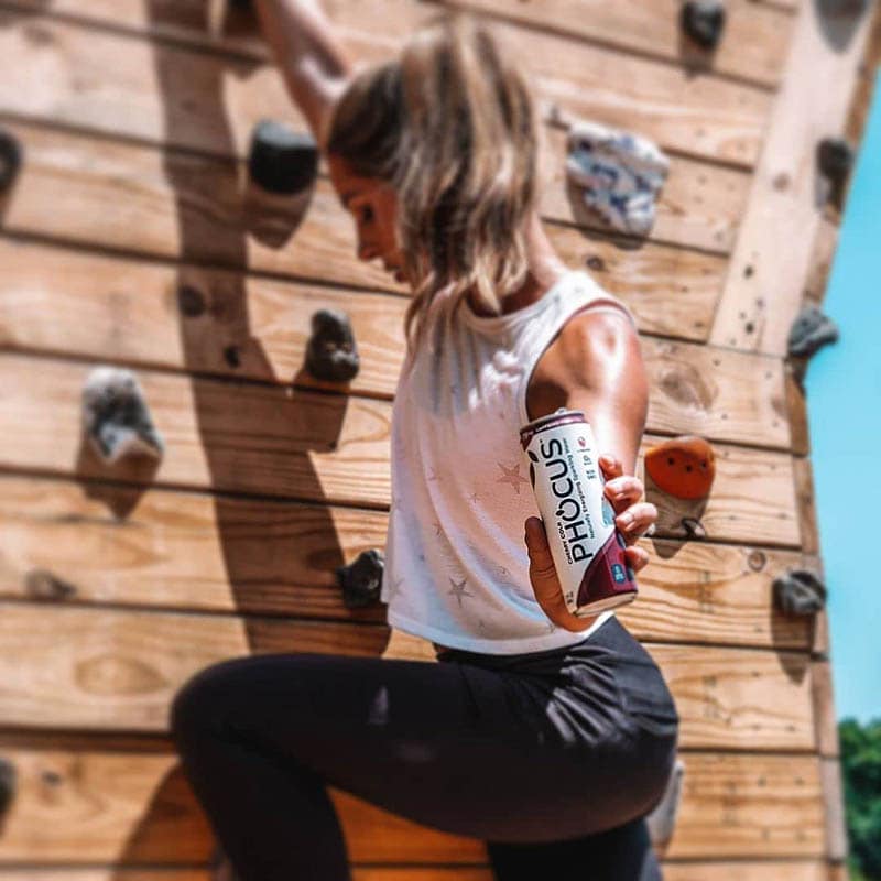 woman holding Phocus Caffeinated Sparkling Water