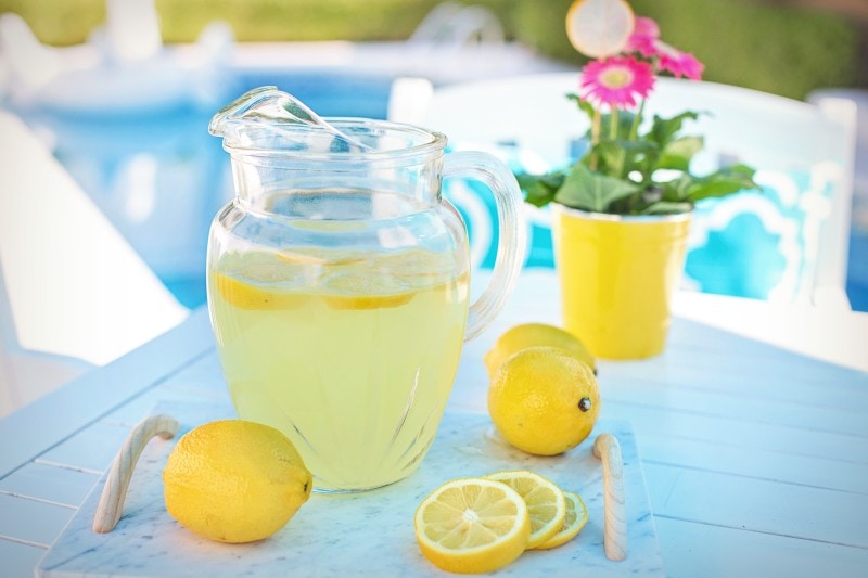 pitcher of lemonade on a table outside_jumpstory