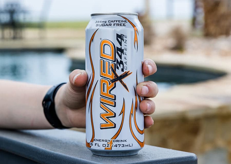 hand holding a can of Wired Energy Drinks Extreme Energy Supplement