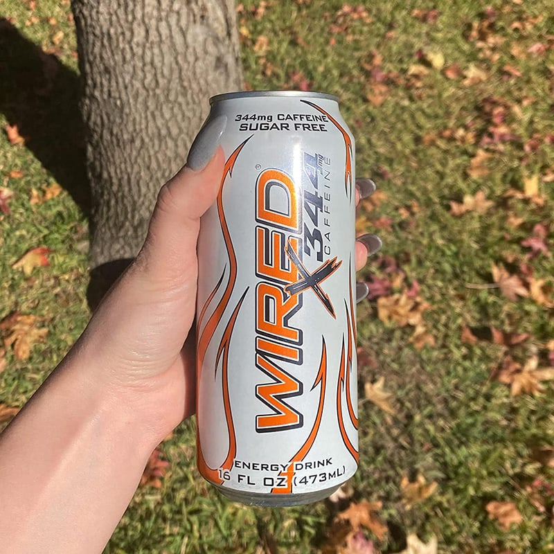 holding a can of Wired Energy Drinks Extreme Energy Supplement